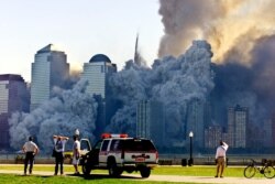FILE - The remaining tower of New York's World Trade Center, Tower 2, collapses in a cloud of dust and debris Sept. 11, 2001. Some conspiracy theorists believe the towers were demolished by powerful, unknown people or forces.