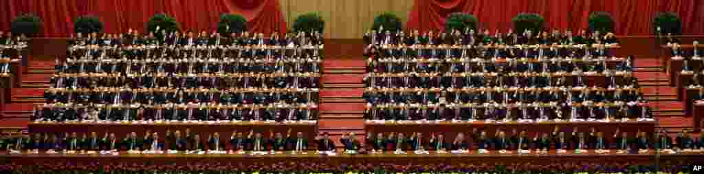 China's leaders raise their hands to show approval for a work report at the closing ceremony for the 18th Communist Party Congress, Beijing, November 14, 2012. 