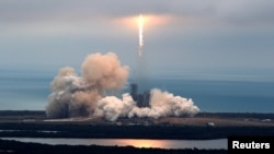 FILE - A SpaceX Falcon 9 rocket disappears into clouds after it lifted off on a supply mission to the International Space Station from historic launch pad 39A at the Kennedy Space Center in Cape Canaveral, Florida, U.S., February 19, 2017.