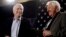 FILE - Sen. John McCain, R-Ariz., left, smiles as he gets a pat on the back from longtime friend and supporter Lt. Col. Orson Swindle, USMC Ret., Feb. 18, 2010, at a rally in Phoenix, Arizona.