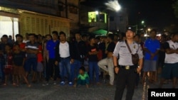 A police officer stands guard after the arrest of a suspected terrorist in Sibolga, North Sumatra province, Indonesia, March 12, 2019. Photo by Antara Foto.
