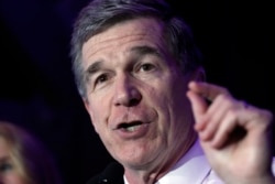 FILE - North Carolina Gov. Roy Cooper speaks to supporters in Raleigh, N.C., March 3, 2020.