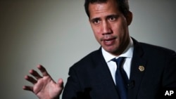 FILE - Leader of Venezuela's political opposition Juan Guaido talks to a journalist during an interview with Associated Press in Brussels, Jan. 22, 2020. 