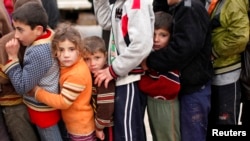 Trẻ em tỵ nạn Syria xếp hàng chờ nhận cứu trợ từ các cơ quan nhân quyền Thổ Nhĩ Kỳ tại trại tỵ nạn Bal al-Salam gần biên giới Thổ Nhĩ Kỳ, 22/12/2012