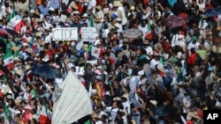 FILE - Demonstrators march demanding respect for Mexico and its migrants, in the face of perceived hostility from the administration of U.S. President Donald Trump, in Mexico City, Feb 12, 2017.