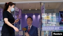 A woman walks past Foxconn's founder Terry Gou's presidential election campaign headquarter in Taipei, Taiwan, Oct. 24, 2023.