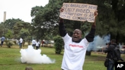 FILE - Demonstrators run from tear gas fired by police at a protest against corruption, in downtown Nairobi, Kenya, on Aug. 21, 2020. A report released by the U.S. trade office on March 29, 2024, said that senior government officials demand bribes before awarding contracts.