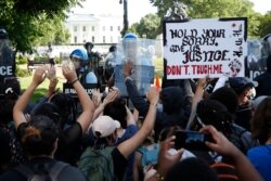 Demonstrators gather to protest the death of George Floyd, May 31, 2020, near the White House in Washington.