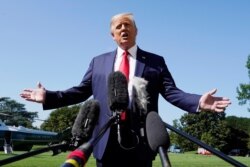 President Donald Trump speaks with reporters as he walks to Marine One on the South Lawn of the White House, Aug. 17, 2020.