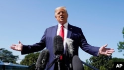 President Donald Trump speaks with reporters as he walks to Marine One on the South Lawn of the White House, Aug. 17, 2020.