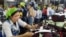 FILE - Cambodians work inside a factory in Phnom Penh, May 10, 2004 photo. 