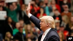 Republican presidential candidate, Donald Trump waves to the crowd during a rally at Radford University in Radford, Virginia, Feb. 29, 2016.