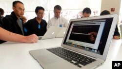 FILE - The new Apple Macbook Air laptop is seen on display at Apple headquarters in Cupertino, Calif.