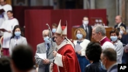 FILE - Pope Francis celebrates Mass in St. Peter's Basilica at the Vatican, May 31, 2020.