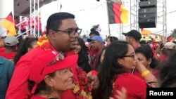 FILE - Irfaan Ali, presidential candidate for Guyana's opposition People's Progressive Party, meets with supporters, ahead of the March 2nd presidential election, in Georgetown, Guyana, Jan. 18, 2020.