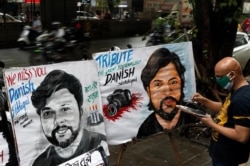 An artist applies finishing touches to a painting in memory of Reuters journalist Danish Siddiqui, outside an art school in Mumbai, India, July 16, 2021.