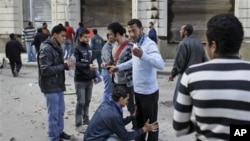 Volunteers check other anti-government protesters to search for and prevent weapons and infiltrators entering the demonstration after brief clashes with pro-government supporters in Talaat Harb square near Tahrir square, Cairo, February 4, 2011