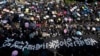 Protesters carrying umbrellas and a huge banner reading "Hong Kong police deliberate murder" march on a street in Hong Kong, Oct. 20, 2019. Authorities are beefing up security ahead of an unauthorized rally by pro-democracy protesters.