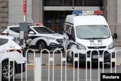 FILE - An escorted police van believed to be carrying Huayuan Real Estate Group former chairman Ren Zhiqiang leaves Beijing No. 2 Intermediate People's Court, where Ren faces corruption trial, in Beijing, Sept. 11, 2020.