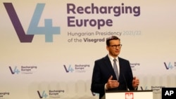 Polish Prime Minister Mateusz Morawiecki addresses the press in Budapest, Hungary, November 23, 2021.