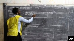 Vote counting takes place after polling station closed in Maputo, Mozambique, Oct. 15, 2019. 