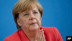 German Chancellor Angela Merkel gestures during her annual summer news conference in Berlin, Germany, Aug. 31, 2015.
