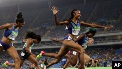 Brianna Rollins from the United States celebrates after winning the gold medal in the women's 100-meter hurdles final during the athletics competitions of the 2016 Summer Olympics at the Olympic stadium in Rio de Janeiro, Brazil, Wednesday, Aug. 17, 2016.