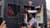 FILE - Security personnel detain supporters of former Prime Minister Imran Khan during a protest against the Pakistan Election Commission, in Lahore, March 10, 2024. Pakistan's National Assembly on June 28, 2024, criticized a U.S. call for an investigation of recent elections.