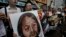 Protesters raise picture of Chinese dissident Tan Zuoren during outside Chinese government's liaison office, Hong Kong, June 9, 2010.