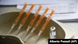 FILE - In this Sunday, March 21, 2021 file photo a vial and syringes of the AstraZeneca COVID-19 vaccine, at the Guru Nanak Gurdwara Sikh temple, on the day the first Vaisakhi Vaccine Clinic is launched, in Luton, England. (AP Photo/Alberto Pezzali, File)