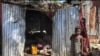 A child stands in front of a makeshift home in the Ma Drapo camp. (Matiado Vilme/VOA Creole) 
