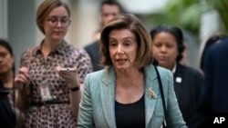 FILE - Speaker of the House Nancy Pelosi speaks to reporters as she arrives for a meeting with fellow Democrats, on Capitol Hill, in Washington, March 10, 2020. 