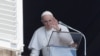 FILE - Pope Francis waves as he leaves after leading Angelus prayer from his window at the Vatican following intestinal surgery, at the Vatican, July 18, 2021.