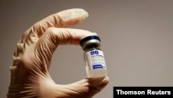 FILE PHOTO: a medical specialist holds a vial of Sputnik V vaccine against the coronavirus in a department store in Moscow, Russia, Feb 2, 2021.