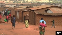 FILE - Refugees of various nationalities walk through Dzaleka refugee camp, Dowa district, in Malawi's Central region, June 20, 2018.
