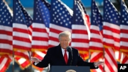 FILE - President Donald Trump speaks to crowd before boarding Air Force One at Andrews Air Force Base, Maryland, Jan. 20, 2021.