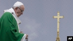Pope Francis spreads incense on the alter during an open-air Mass at Santakos Park, in Kaunas, Lithuania, Sept. 23, 2018. 