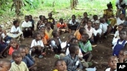 Refugee children from the Democratic Republic of Congo attend class in a forest near the town of Gangania, more than 850 km north of Brazzaville, the capital of neighboring Congo. Most of the teachers are also refugees who fled inter-ethnic violence in th