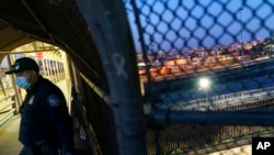 A US border agent stands on the Paso del Norte international bridge that borders Ciudad Juarez, Mexico, and El Paso, Texas, in the United States, Sept. 10, 2021.