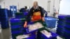 FILE - Workers unload fish at the port of Roscoff, western France, Nov. 12, 2020. 