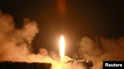 FILE - A tactical rocket firing drill carried out by units of the Korean People's Army (KPA) Strategic Force is seen during a visit by Kim Jong Un in the western sector of the front in this undated photo released by N. Korea's Korean Central News Agency, July 10, 2014.