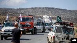 FILE - A convoy of trucks from Doctors Without Borders carrying medical supplies stops by the side of the road after receiving news that the road ahead has been closed by the Ethiopian military, in the Tigray region of northern Ethiopia, May 8, 2021.