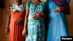 FILE - Surrogate mothers pose for a photograph inside a temporary home for surrogates provided by Akanksha IVF centre in Anand town, about 70 km (44 miles) south of the western Indian city of Ahmedabad.