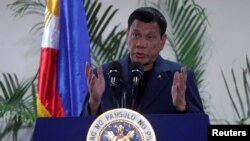 Philippine President Rodrigo Duterte interacts with reporters during a news conference upon his arrival from a four-day state visit in China at the Davao International Airport in Davao city, Philippines, Oct. 21, 2016.