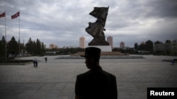 FILE - A soldier stands guard at the doors of the War Museum visited by foreign reporters during a government-organized tour in Pyongyang, North Korea, Oct. 9, 2015.