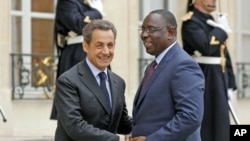 France's President Nicolas Sarkozy (L) greets Senegal's newly-elected President Macky Sall at the Elysee Palace in Paris, April 18, 2012.