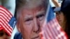 A supporter holds a portrait of former U.S President Donald Trump during a rally in Huntington Beach, California, a day after Trump was shot in an assassination attempt during a rally in Pennsylvania on July 13, 2024. (Etienne Laurent/Reuters)