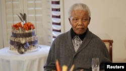 In this file photo, former South African president Nelson Mandela is shown observing his 94th birthday at his house in Qunu, Eastern Cape, July 18, 2012.