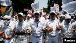 Members of hardline Islamic groups, including the Islamic Defenders Front, protest to show their displeasure over incoming Jakarta governor Basuki Tjahaja Purnama, who is an ethnic Chinese Christian, in Jakarta, Sept. 24, 2014.