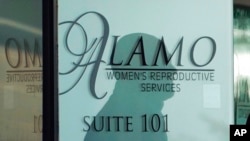 The shadow of a security guard is seen on the doorway to Alamo Women's Reproductive Services, Oct. 7, 2021, in San Antonio, Texas. 